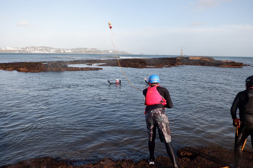 Throwline being thrown to swimmer in water